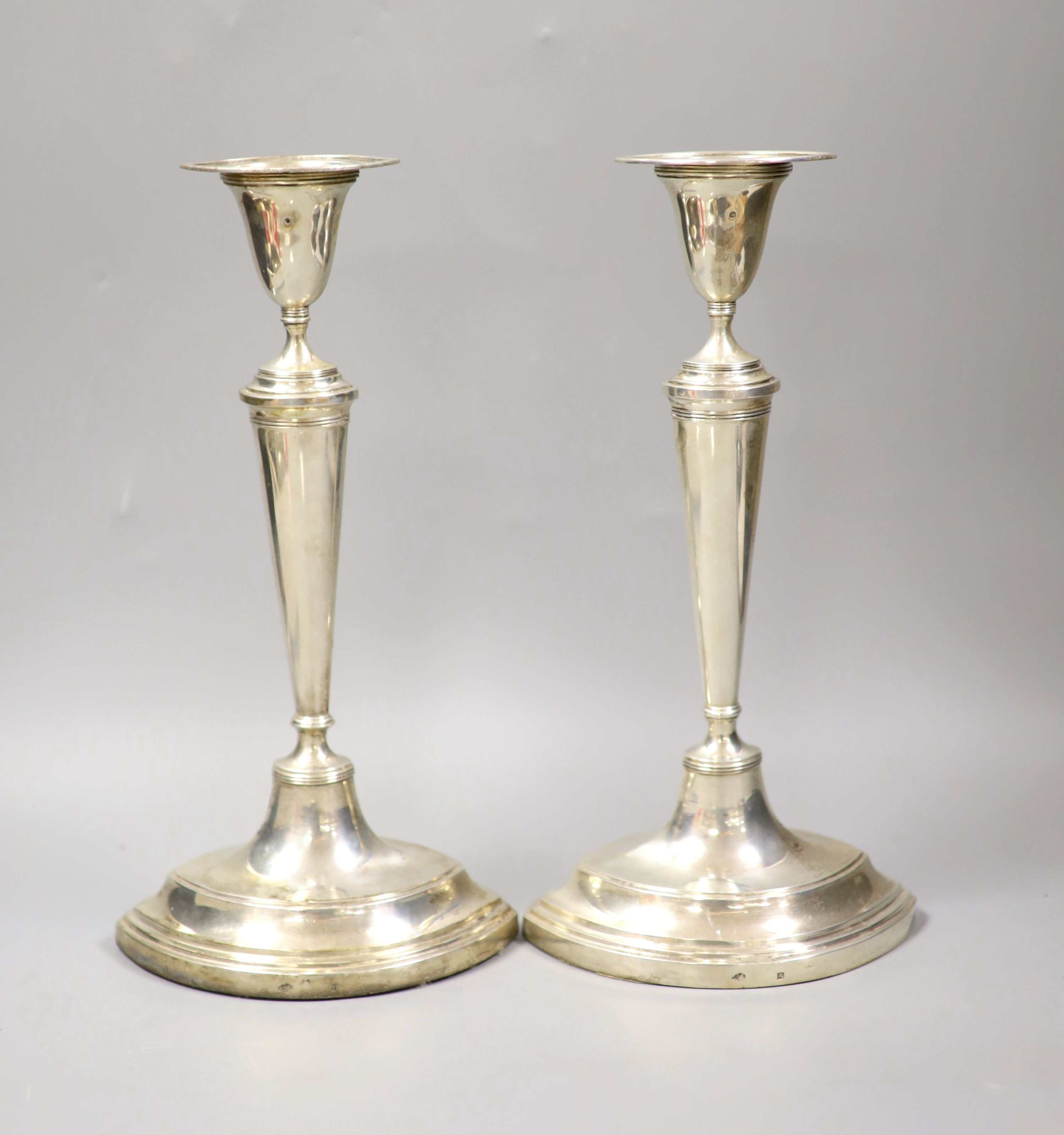 A pair of 19th century Dutch white metal oval candlesticks, 28.1cm, weighted.